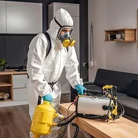 Pest control technician preparing inspection equipment in Woolwich home